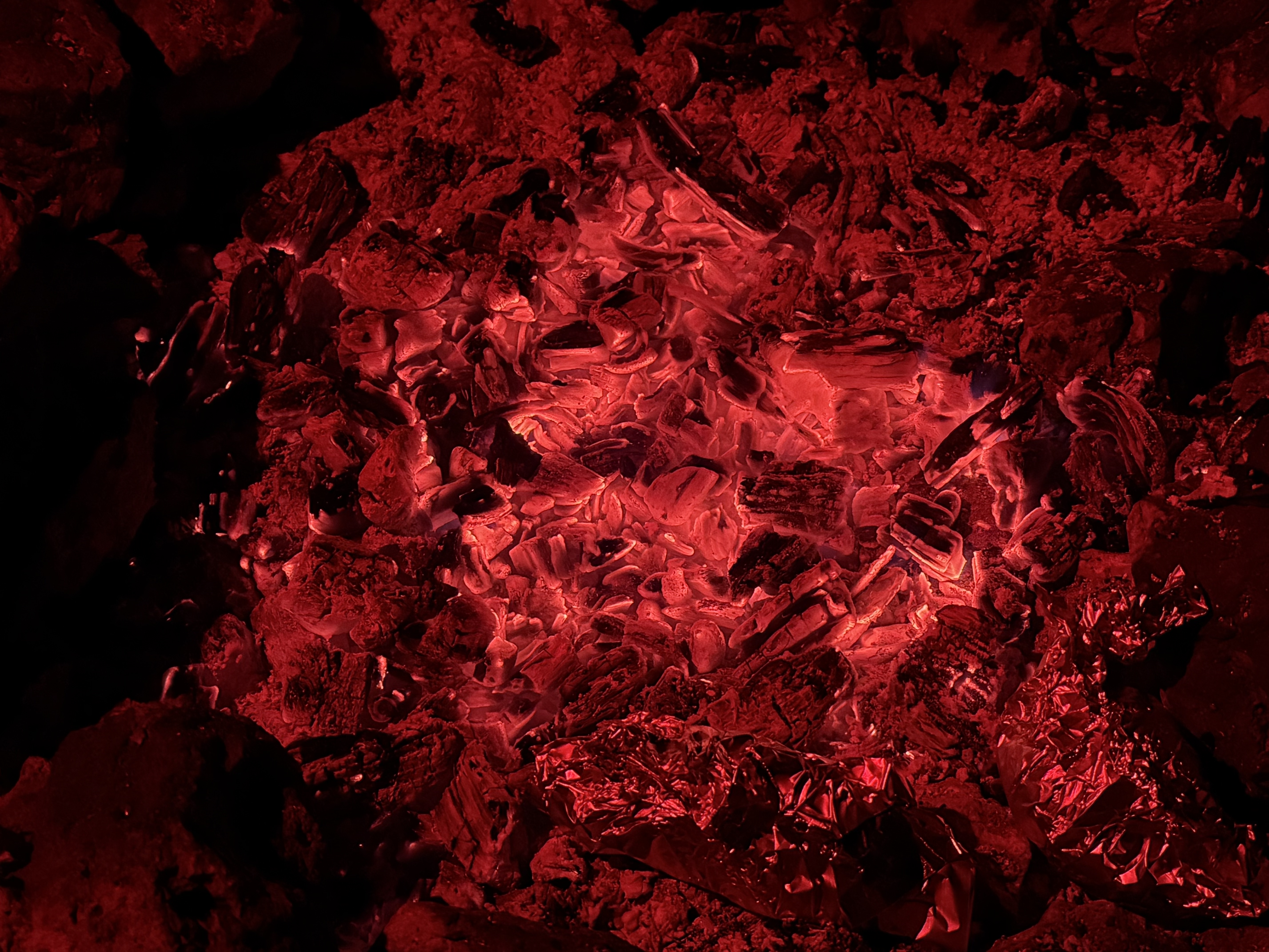 Glowing red campfire coals at night, Jacob Lake