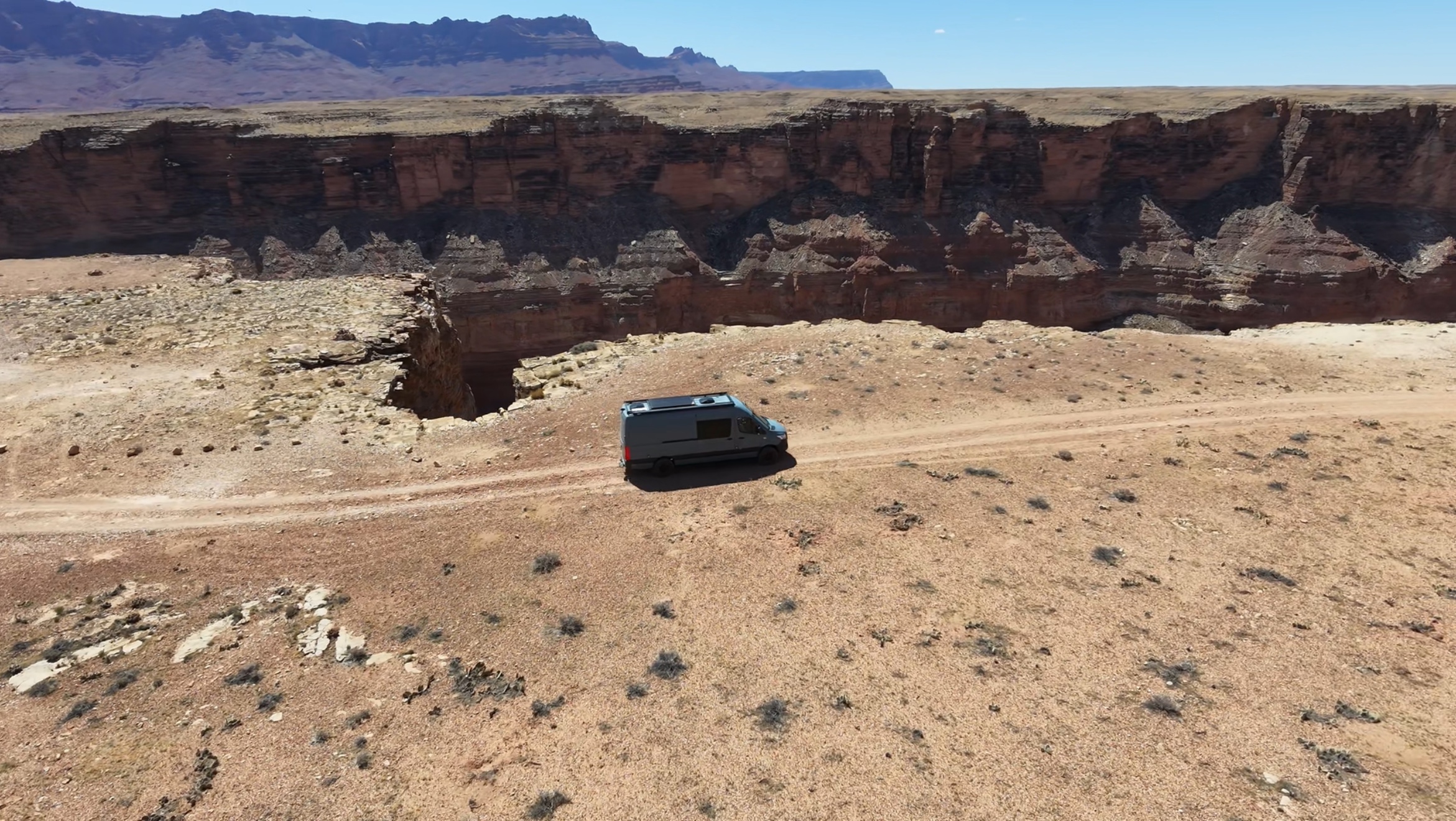 Van on a dirt road at the edge of the canyon, Arizona Strip