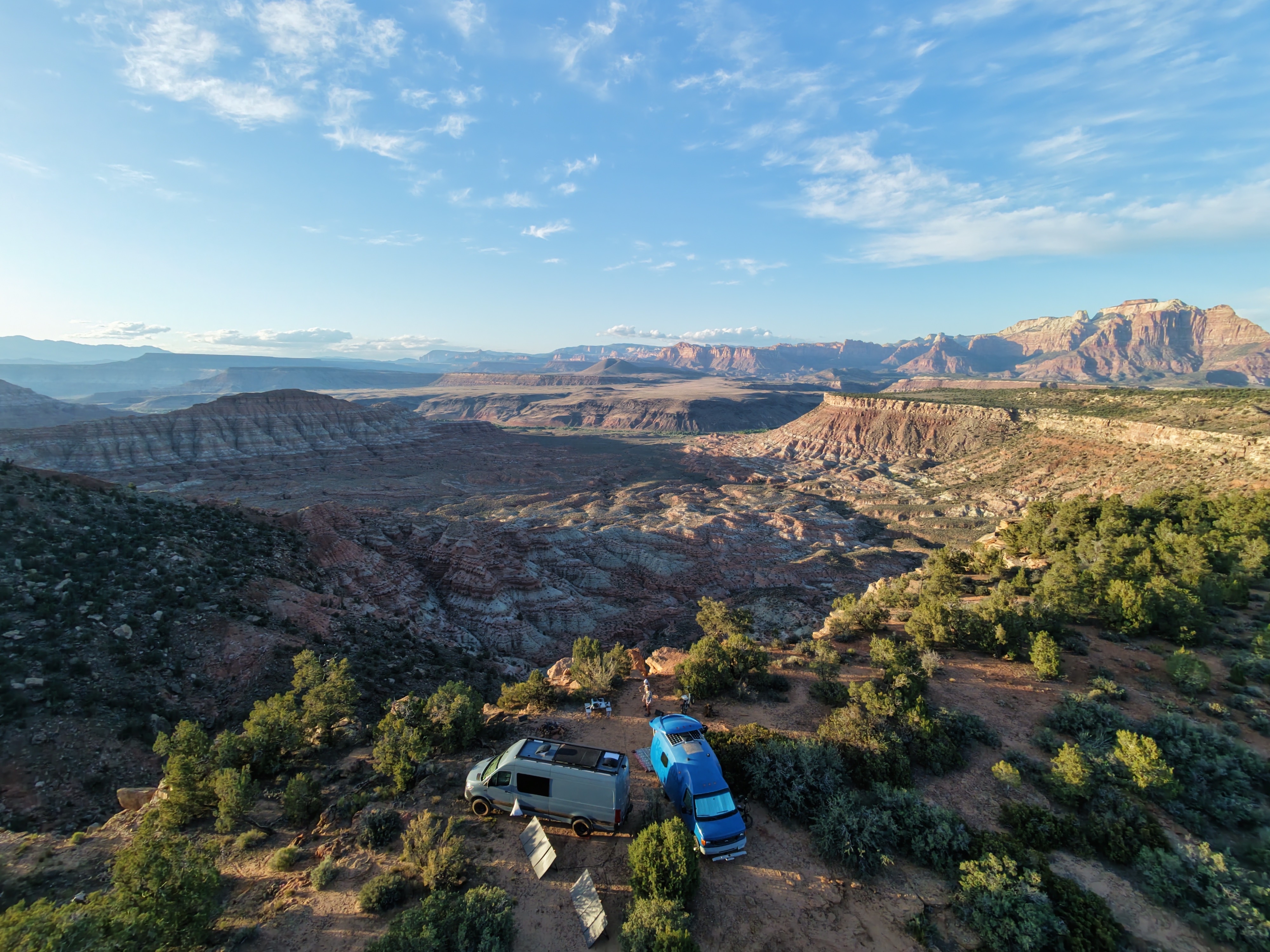 Drone shot of two vans at camp above the canyon panorama, Southern Utah