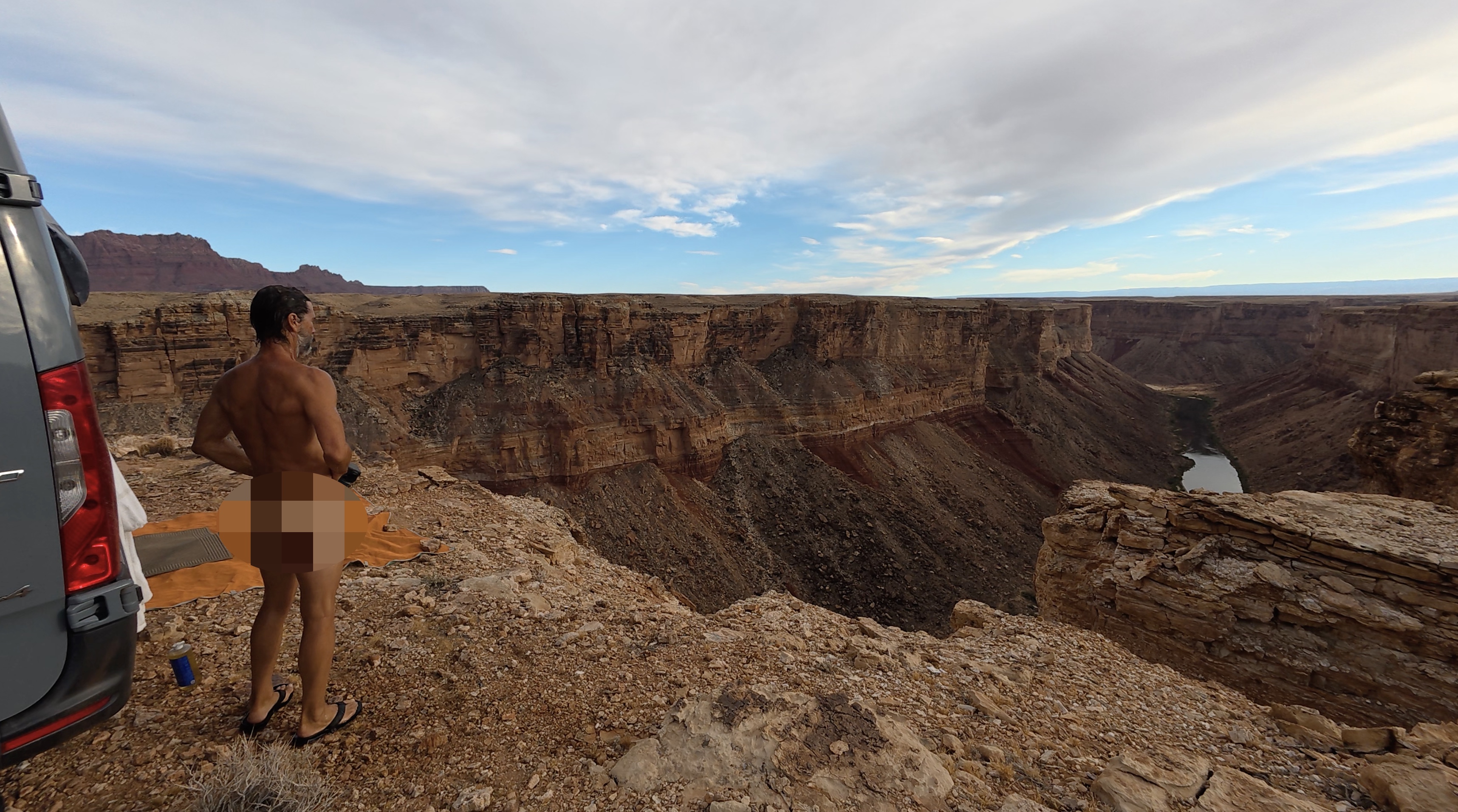Standing at the canyon rim beside the van, 950 feet above the Colorado River