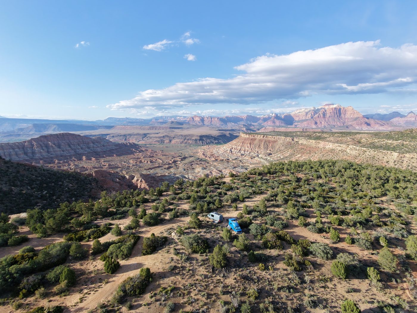 Drone shot of two rigs camped above the Zion panorama